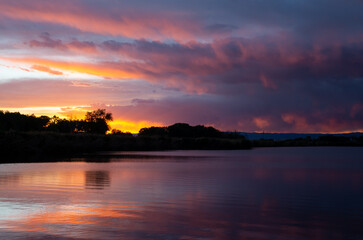 Western sunset reflected in calm water