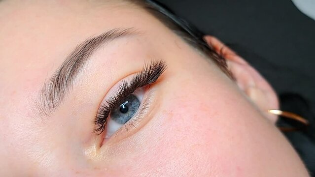 close up of eye with eyelash extensions in beauty salon ,macro