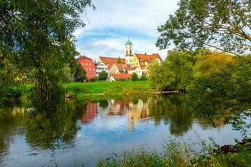 Fototapeta na wymiar View of the Rococo style St. Mang Church and monastery complex in the Stadtamhof village island area, across the Danube River from the Bavarian town of Regensburg, Germany.