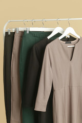 Women's Clothes. Clothes rack with stylish and elegant garments in fashion atelier. Good quality timeless fashion pieces.