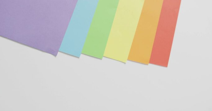 Video of rainbow sheets over white surface with copy space