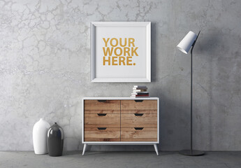 Square white poster Frame Mockup hanging above chest in room