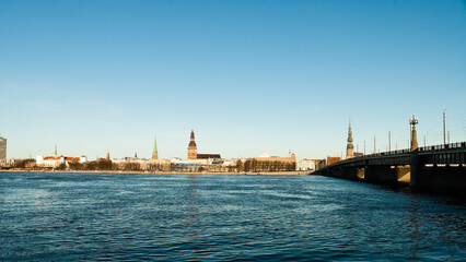 Fototapeta premium riga, panorama of the city, in the background the blue sky in the foreground is the river
