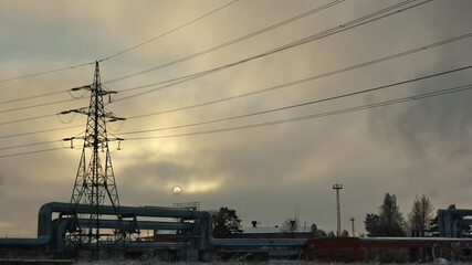pipeline and power lines against the gray sky