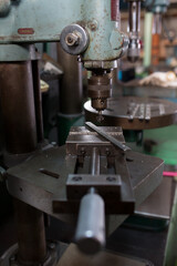Part machining with drilling machine