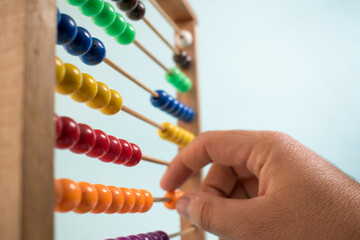 Colorful wooden abacus on green background