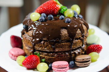 chocolate cake with strawberries, grape and other fruit