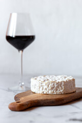 Camembert cheese served with a glass of wine