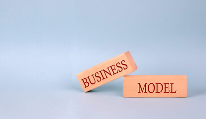 BUSINESS MODEL text on the wooden block, blue background