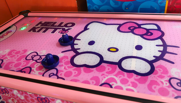 Air hockey Hello Kitty. Arcade games room. Video game park for children and teenagers. 
Electronic board game with the image of Hello Kitty.