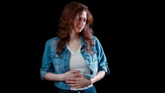 (Camera: ARRI ALEXA, 35mm lens, real time) A young caucasian woman has a stomache ache. For more variations of this clip, check out this seller's other videos.