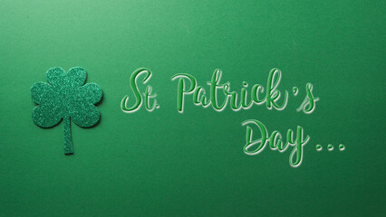 Happy St Patrick's Day decoration concept made from shamrocks ( clover leaf) and the text on green...