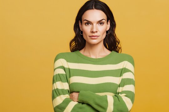 confident calm brunette latin woman wearing casual cozy green knitted sweater hold hands in pockets looking camera isolated on plain yellow background studio portrait People lifestyle. Generative AI