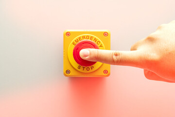 Stop Button and the Hand of Worker About to Press it. emergency stop button. Big Red emergency button or stop button for manual pressing. - obrazy, fototapety, plakaty