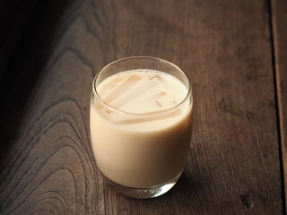 glass of soy milk on wooden table
