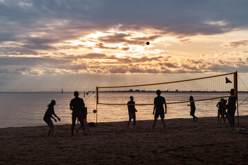 sunset on the beach playing volleyball
