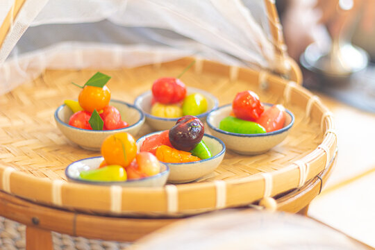Gelatin dipped fruit or vegetable shaped mung beans. called  Luk chup or look choop in thailand and Marzipan in Portuguese