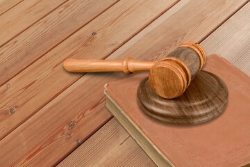 Law book and wooden gavel on desk