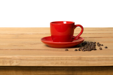 Red cup of fresh coffee with coffee beans on wooden table