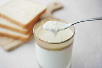 glass of whole cream milk on table , Cream of milk.