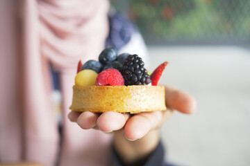 women eating berry fruit tart 