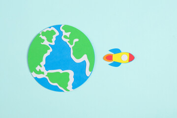 Space shuttle and planet earth on a blue background. Children's creativity