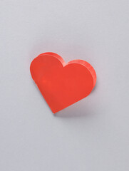 Red paper heart shaped valentine on gray background