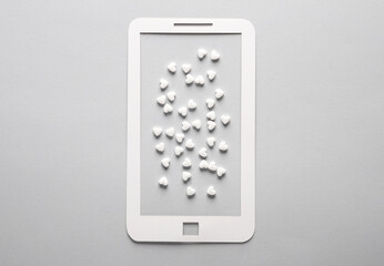Paper-cut smarton with a lot of hearts on a gray background. Followers, love concept
