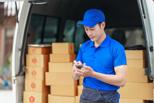 Delivery Man Asia People Checking Portable Delivery Device With Parcel Box To Customer Home Address. Typing Message, Using Mobile Smartphone