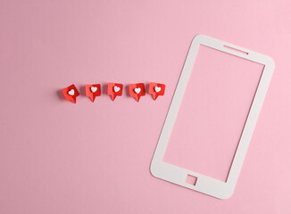 Paper cut smartphone with Social media likes on pink background. Creative minimal layout