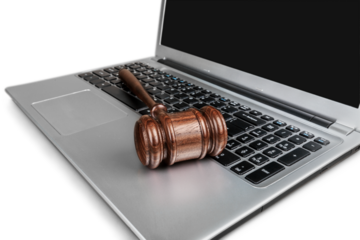 Classic brown justice wooden hammer on laptop