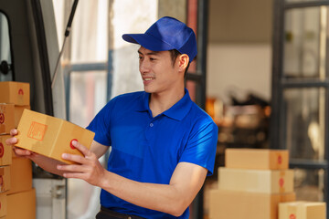 Delivery man asia people checking portable delivery device with parcel box to customer home address.