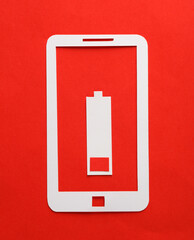 Paper-cut smartphone and low battery level on red background