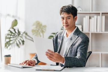 Portrait of bookkeepers asia business man working on tax consultant law in a modern office. Make an account analysis report. real estate investment information financial and tax system concepts