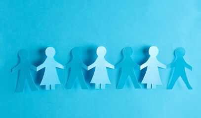 Paper cut chain of people holding hands on blue background. Unity concept