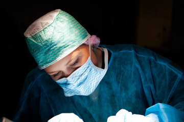 Surgical resident focused on her patient