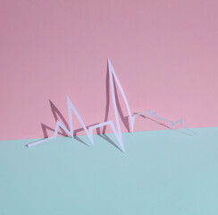 Paper-cut heart rhythm cardiogram on pink blue pastel background. Creative layout