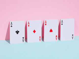 Four aces on blue pink pastel background. Creative layout