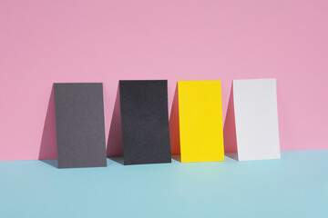 Colored blank business cards on a blue-pink pastel background. Creative minimal layout. Corporate...