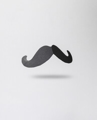 Paper mustache levitating on a gray background - obrazy, fototapety, plakaty