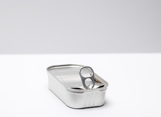 Open empty tin can on white gray background. Top view