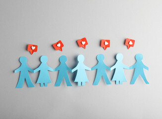 Paper cut human chain and Social media likes on gray background.
