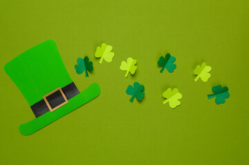 St.Patrick 's Day. Paper leprechaun hat with clover leaves on a green background. March 17. Hand...