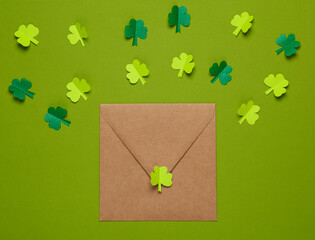 St. patrick's day invitation. Envelope with a festive themed hand-made decor on a green background. Flat lay