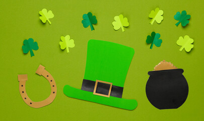 Flat lay st. patrick's day still life. Clover, leprechaun hat, bowler hat with gold and a horseshoe...