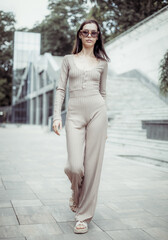 Fototapeta premium Stylish fashionable young woman in sunglasses outdoors. Street fashion