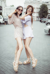 Two young stylish women friend are having fun together in the city. Lifestyle.