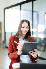 Obraz premium business owner or Asian female marketers are using tablet computer in office work