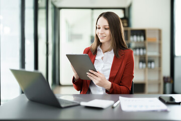 business owner or Asian female marketers are using tablet computer in office work
