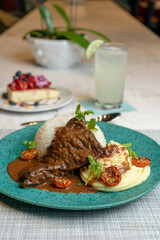 Steak in the pot with mashed potatoes, typical food from Peru.